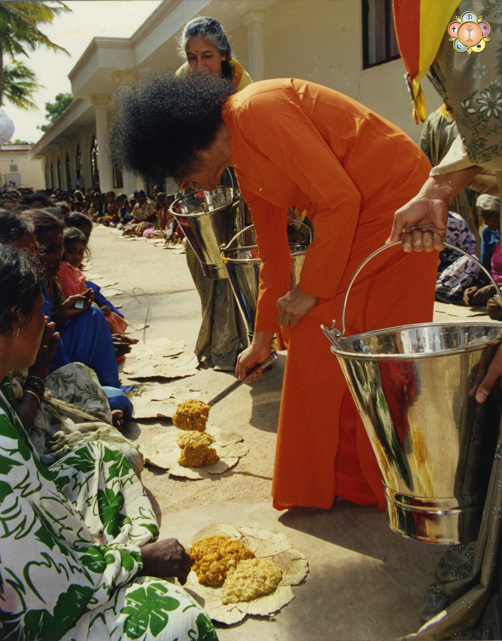 Bhagawan Sri Sathya Sai Baba serving food to devotees